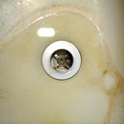 tan sink with residue around water mark from hard water - water softener systems 